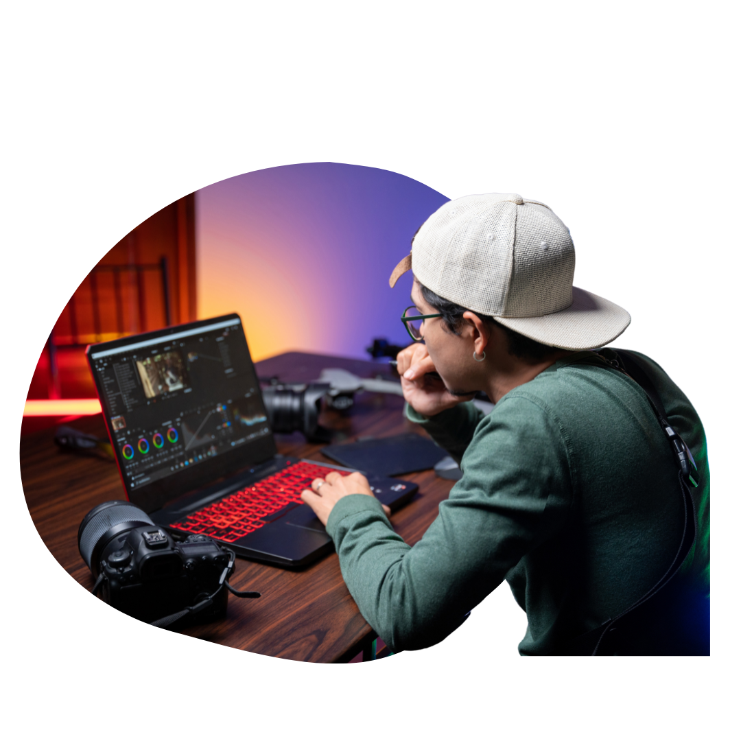 videographer working on a laptop bubble mask